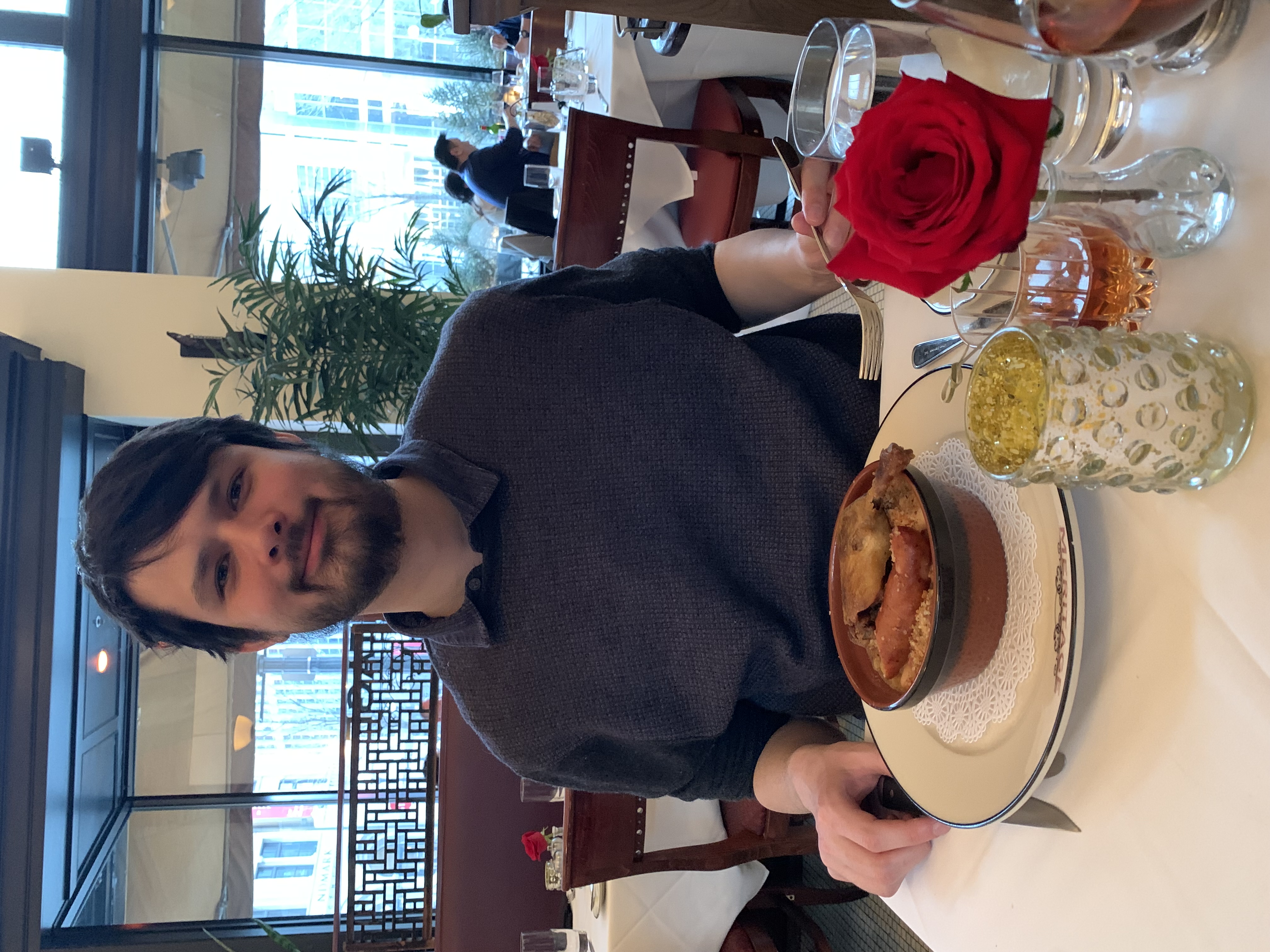 Ian T Moy eating a coq au vin in a restaurant